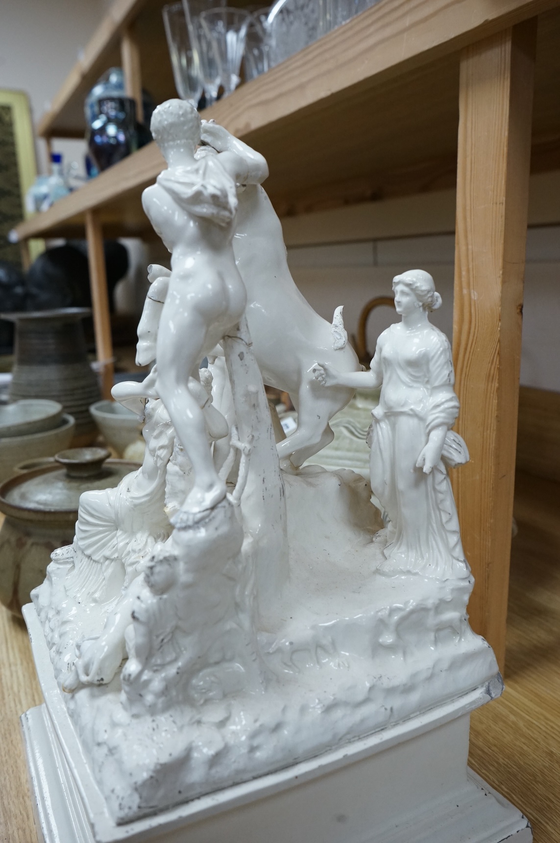 A 19th century Naples tin glazed pottery group of figures wrestling a Europa and the bull, 14in.